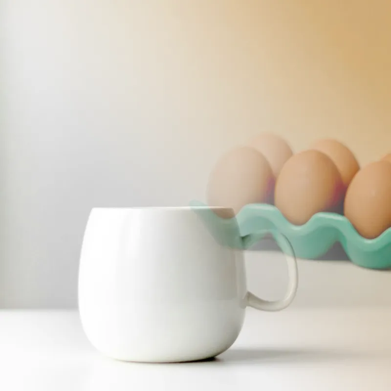 Fluffy vegetable omelette with cheese served in a mug for quick breakfast